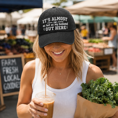 Woman shopping at a market wearing a black washed baseball cap with embroidered funny marriage quote text