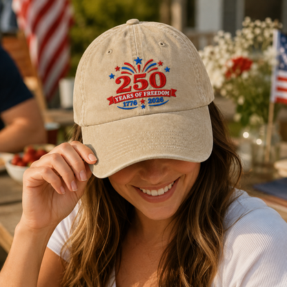 Woman smiling at a backyard barbecue wearing a sand washed baseball cap with embroidered red and blue 250 years of freedom design