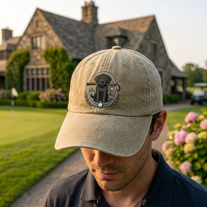 Man wearing a beige cap with a logo in front of a large house.