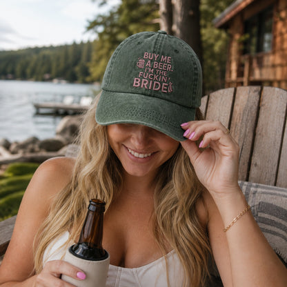 Woman wearing a cap with text by a lake and cabin