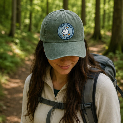 Person wearing a green cap with a logo in a forest