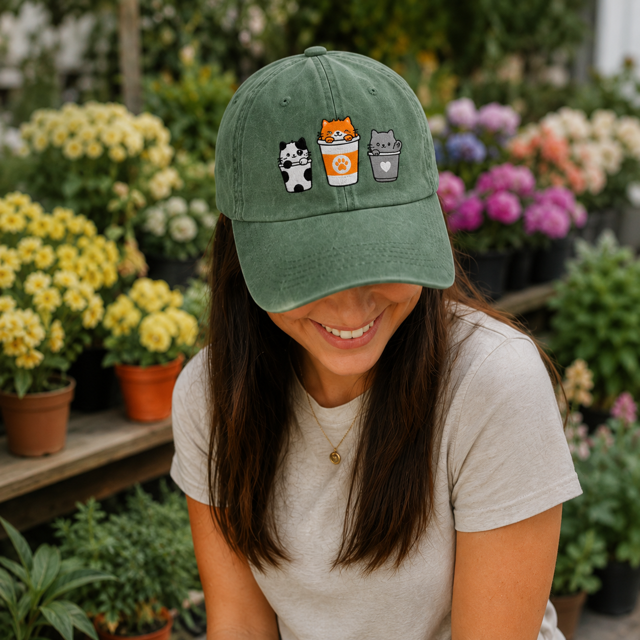 Person wearing a green cap with cartoon character designs in a garden setting
