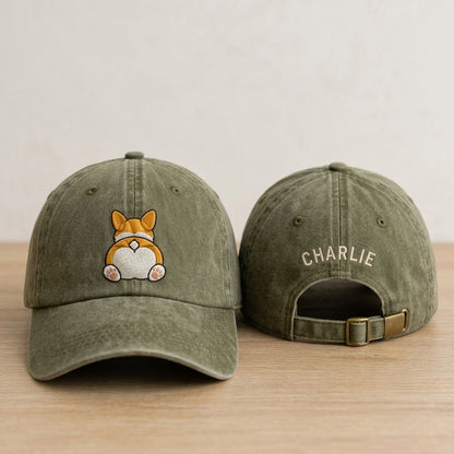 Green baseball cap with a dog illustration on the front and 'CHARLIE' on the back, placed on a wooden surface.