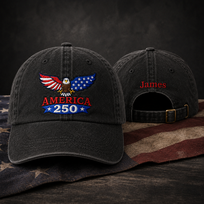Front and back view of a black washed baseball cap with embroidered patriotic America 250 eagle design and custom red name James