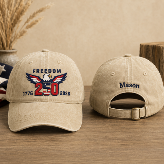 Front and back view of a sand washed baseball cap with embroidered patriotic freedom 250 eagle design and custom name Mason text