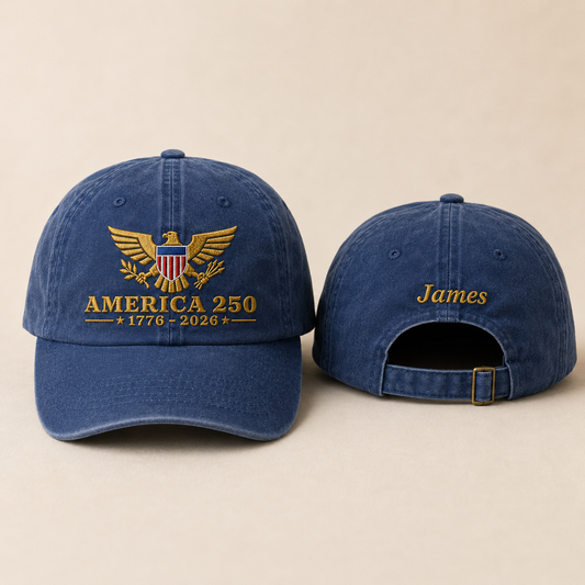 Front and back view of a navy washed baseball cap with gold embroidered America 250 eagle design and custom name James text