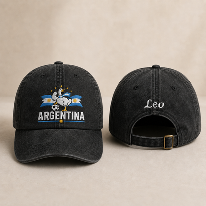 Front and back view of a black washed baseball cap with an embroidered Argentina soccer goose design and custom white name Leo text