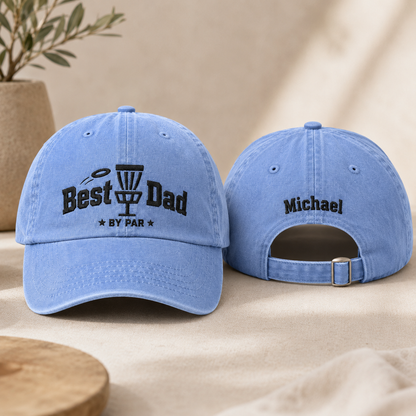 Front and back view of a light blue washed baseball cap with black embroidered disc golf best dad by par design and custom name text