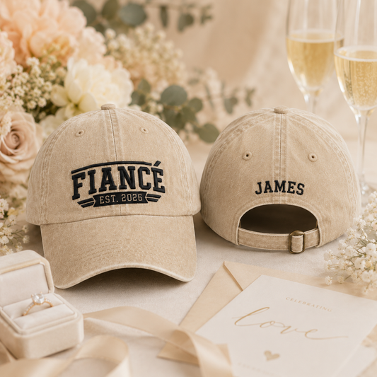 Front and back view of a sand washed cotton baseball cap featuring embroidered black Fiance Est 2026 text and custom name James text