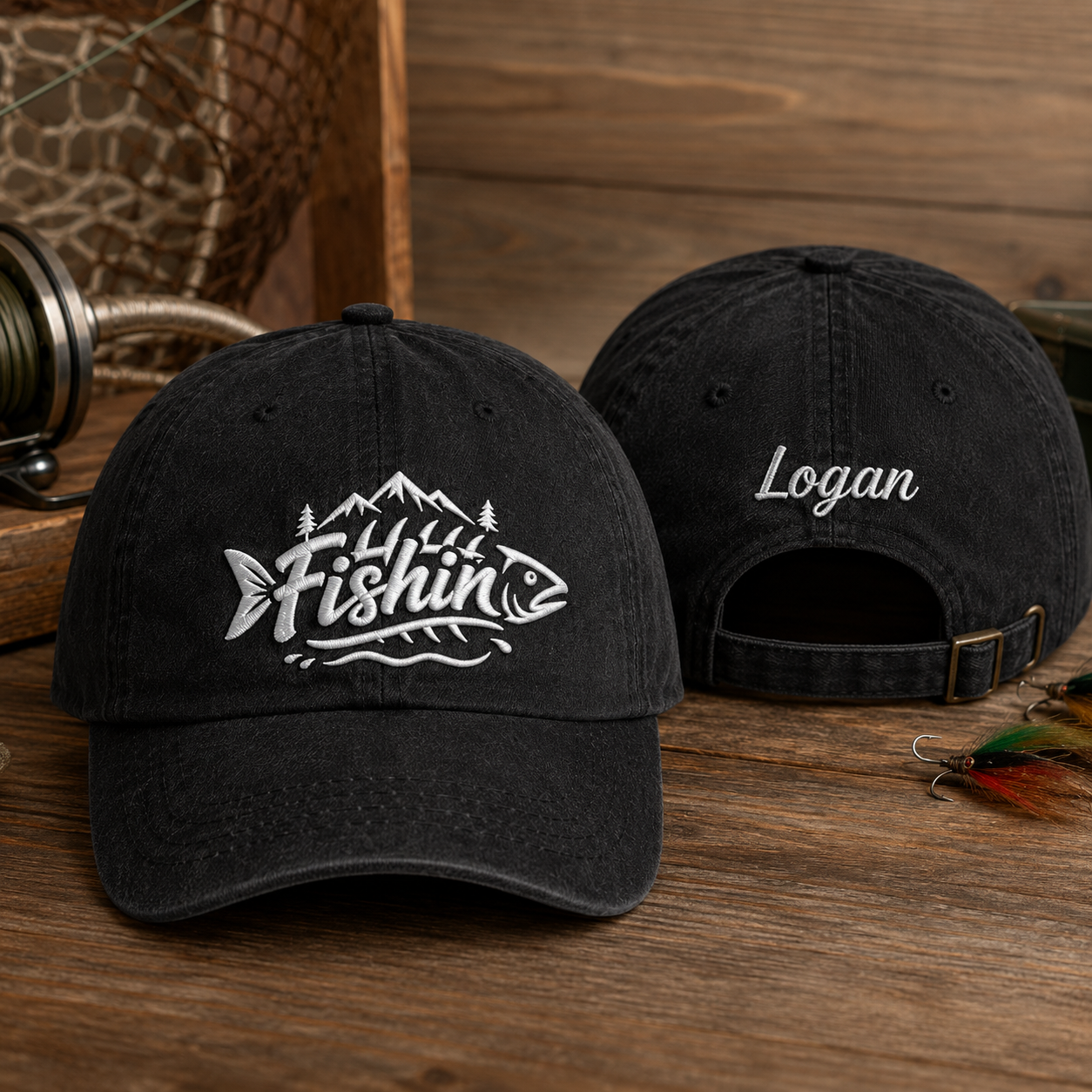 Front and back view of a black washed cotton baseball cap featuring white embroidered Fishin mountain artwork and custom name Logan text