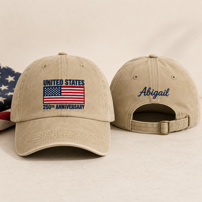 Front and back view of a sand washed baseball cap with embroidered US flag United States 250th anniversary design and custom blue name Abigail