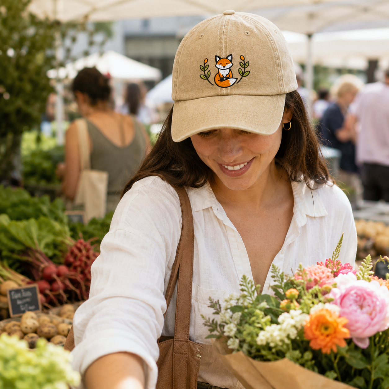 Woman shopping at a local market wearing a sand washed cotton baseball cap with embroidered sleeping fox