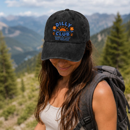 Woman wearing a cap with 'Dilly Club' logo in a mountainous landscape
