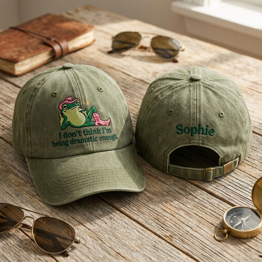 Two green baseball caps on a wooden surface with sunglasses and a compass.