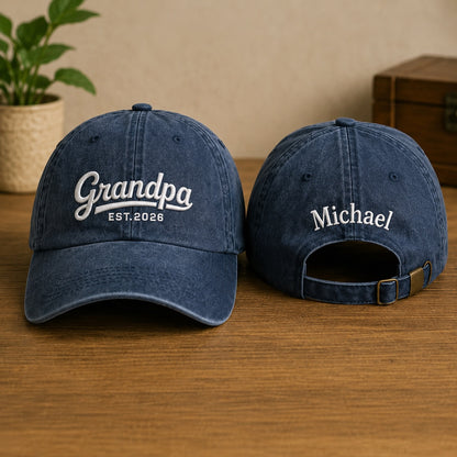 Two blue baseball caps with embroidered text on a wooden surface.