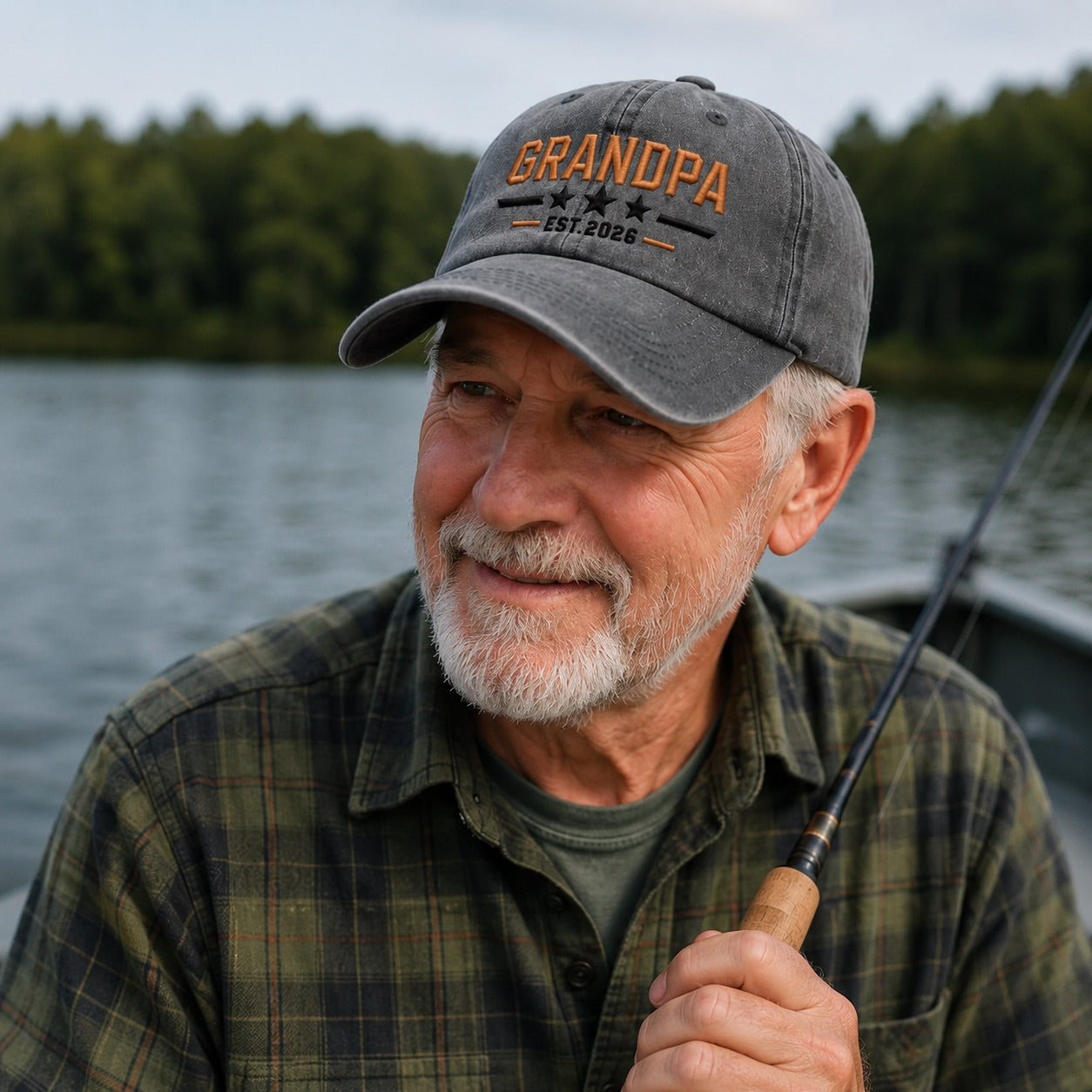 Man wearing a 'GRANDPA' cap by a lake