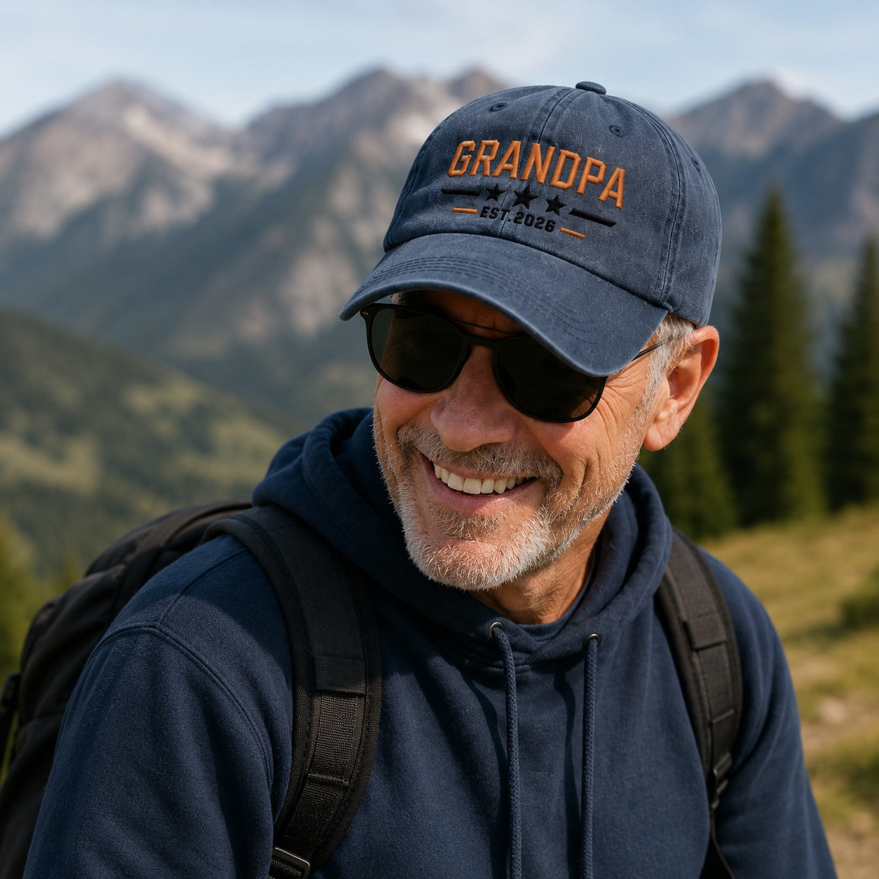 Man wearing a 'Grandpa' cap with mountainous background