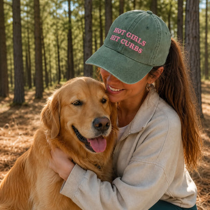 Woman wearing a cap with text hugging a dog in a forest