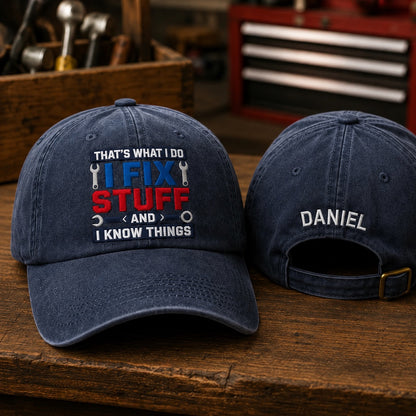 Two navy blue baseball caps on a wooden surface with toolboxes in the background.