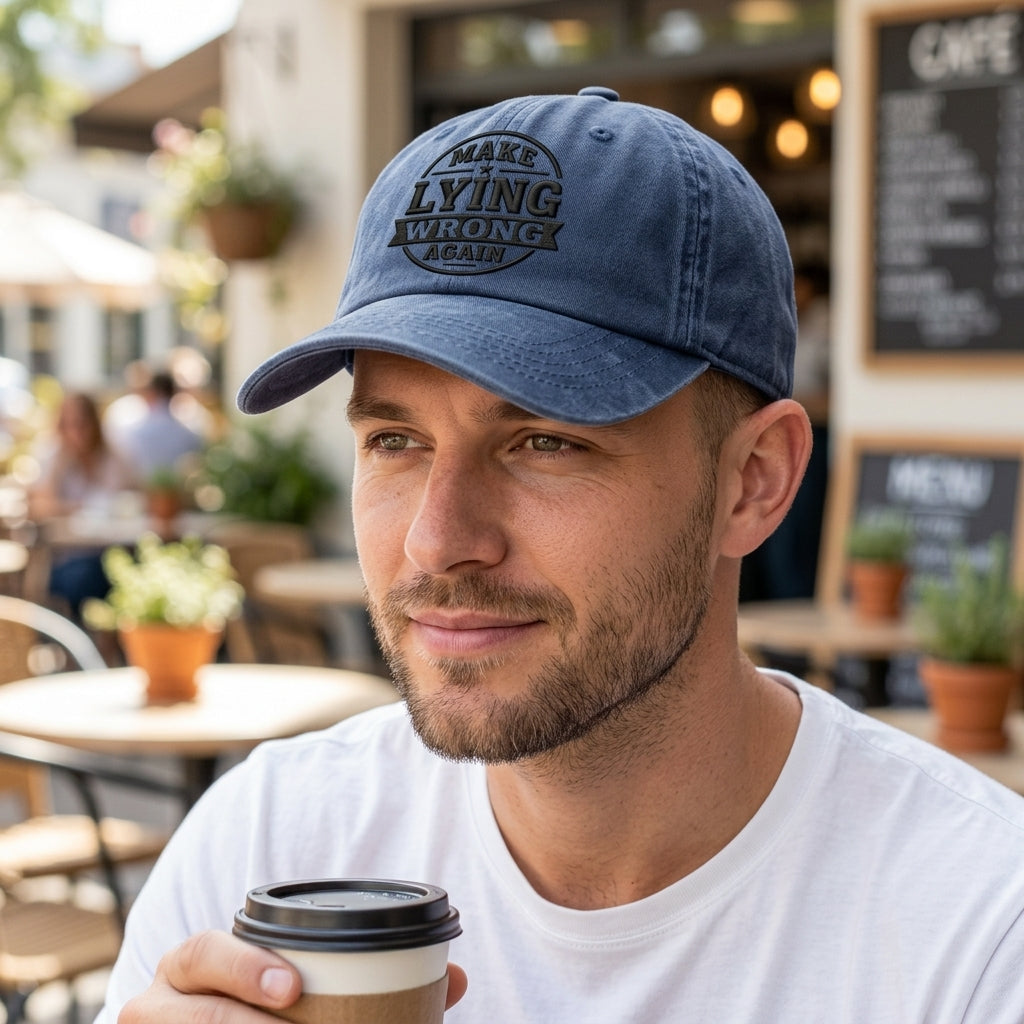 Man wearing a blue cap with text, holding a coffee cup outdoors.
