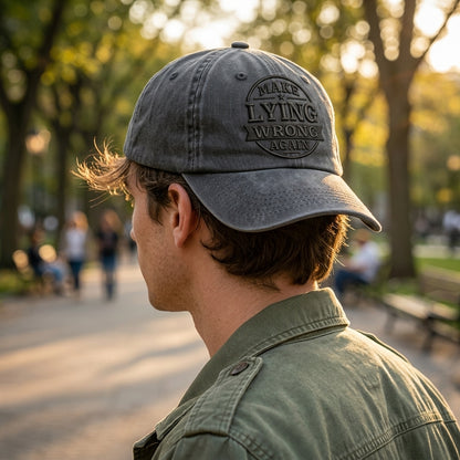 Person wearing a cap with text in a park setting