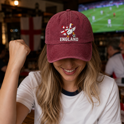 Woman celebrating at a pub wearing a maroon washed baseball cap with an embroidered England soccer goose design