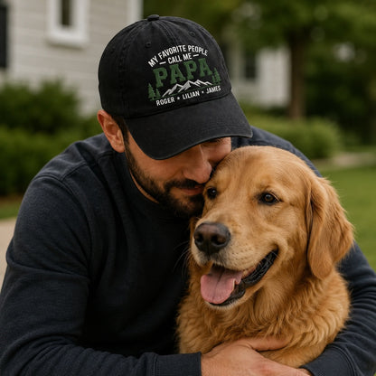 Man wearing a cap with text hugging a golden dog outdoors.