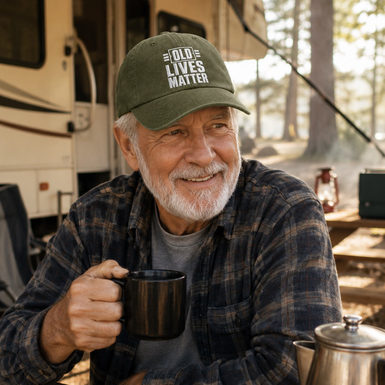 Man wearing a cap with 'Old Lives Matter' text, holding a mug outdoors near an RV.