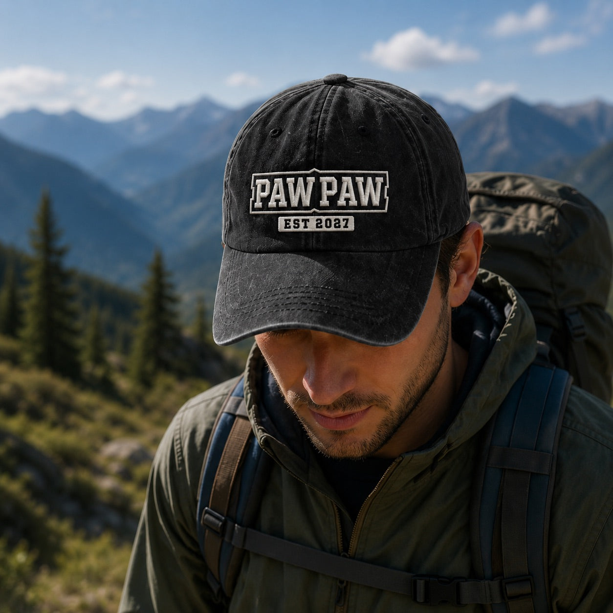 Man wearing a black cap with 'PAW PAW EST 2022' logo, hiking in a mountainous area.