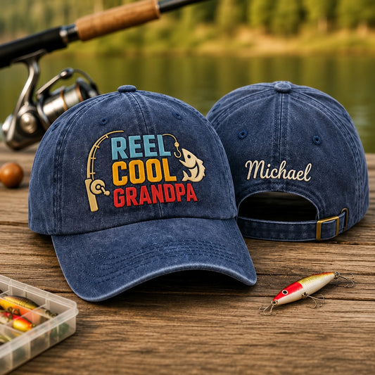 Two blue denim caps with fishing-themed text on a wooden surface with fishing equipment.