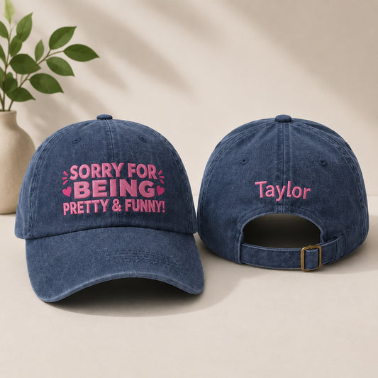 Two blue denim caps with pink text on a beige background