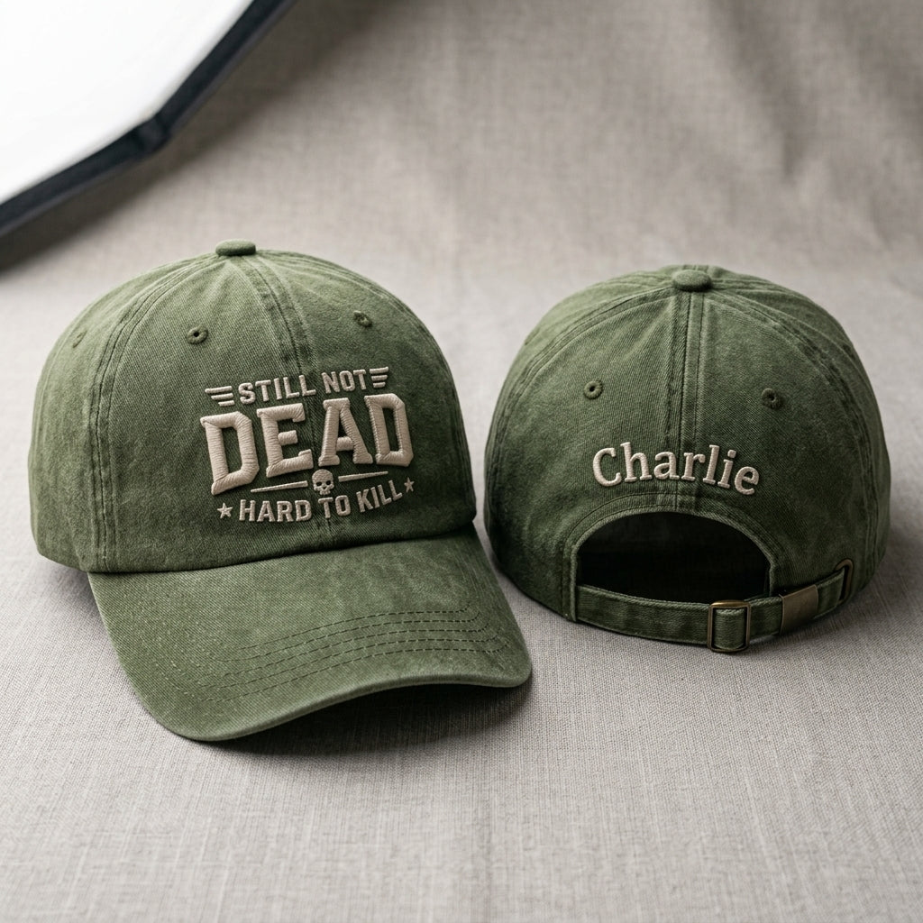 Two green baseball caps with text on a gray surface