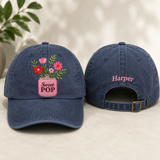 Blue denim cap with floral design and 'Sweet Pop' text on a light background