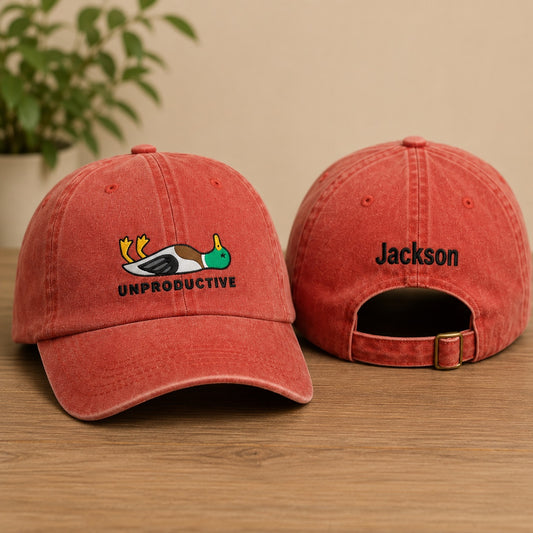 Two red baseball caps with a logo and text on a wooden surface.