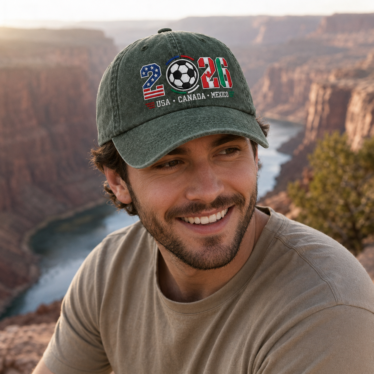 Man smiling outdoors wearing an army green washed baseball cap with embroidered 2026 country flags soccer design