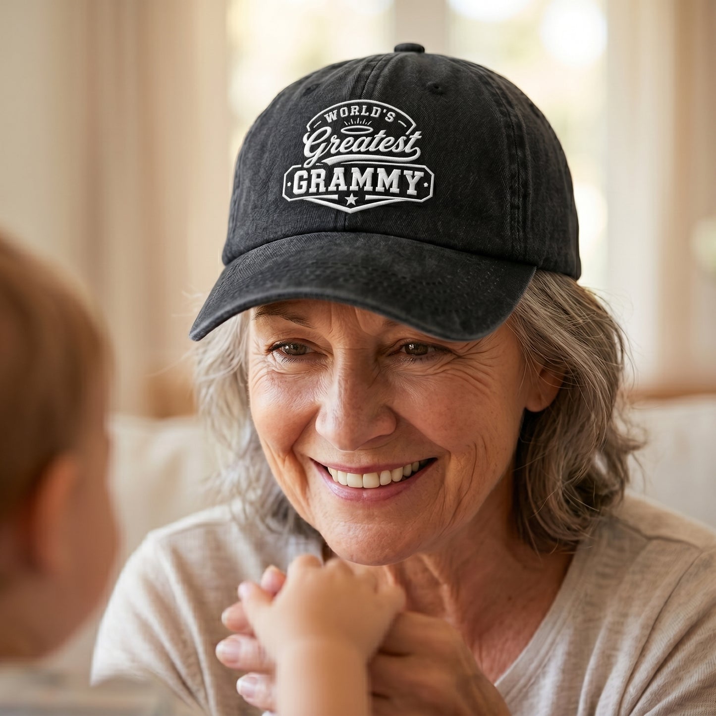 Black washed cotton baseball cap with white embroidered Greatest Grammy design worn by a grandmother.